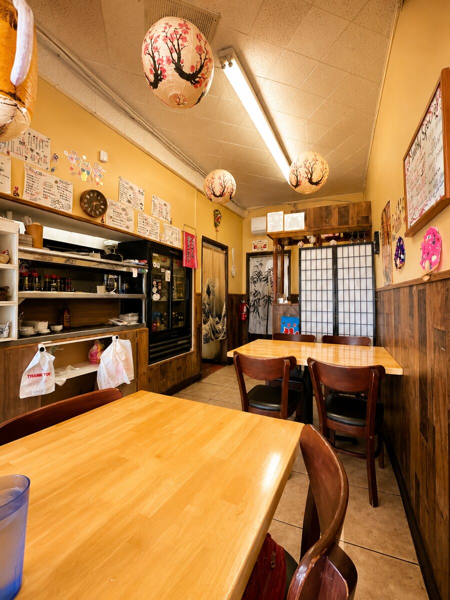 Wooden booths and bamboo blinds inside Sushi Yorimichi