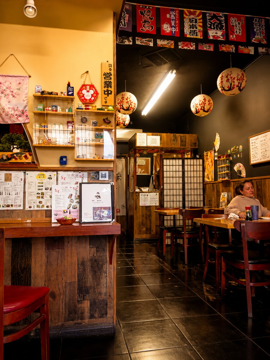 Cherry-blossom paper lanterns and shoji screens inside Sushi Yorimichi